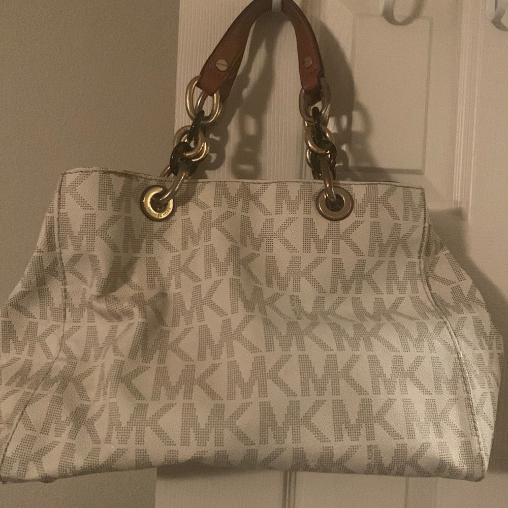 Michael Kors purse. Sturdy bottom. Has wear but still good condition.